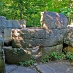 Front view of Dolmen Hidden Abilities with stone entrance